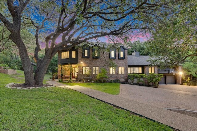 4812 Mantle Dr, Austin, TX 78746 - view of front of house featuring a yard, concrete driveway, brick siding, a garage, and a chimney