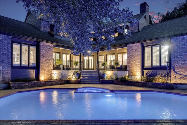 4812 Mantle Dr, Austin, TX 78746 - pool at night featuring stairs and a pool with connected hot tub