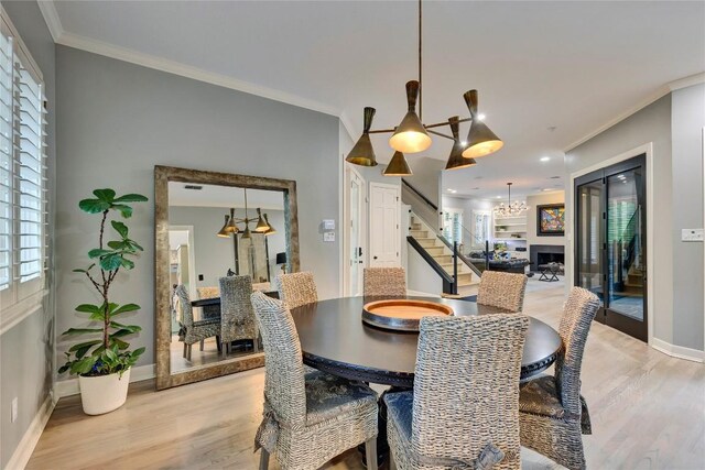 4812 Mantle Dr, Austin, TX 78746 - dining room with stairs, a chandelier, crown molding, light wood finished floors, and healthy amount of natural light
