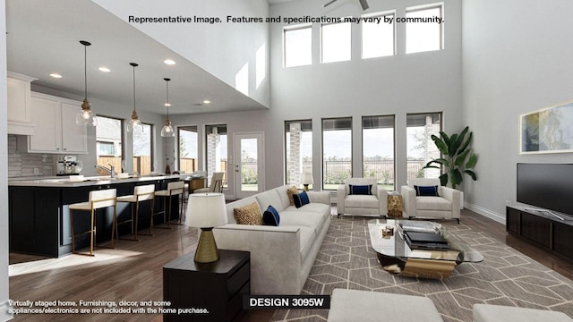 1200 Summer Moon Dr, Georgetown, TX 78628 - living room featuring wood finished floors, a towering ceiling, recessed lighting, and baseboards