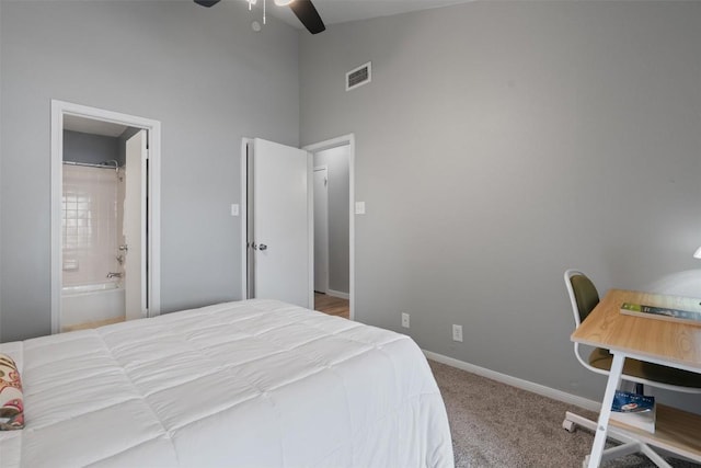 203 E 31st St Unit 304, Austin, TX 78705 - bedroom featuring high vaulted ceiling, carpet floors, baseboards, ensuite bathroom, and a ceiling fan