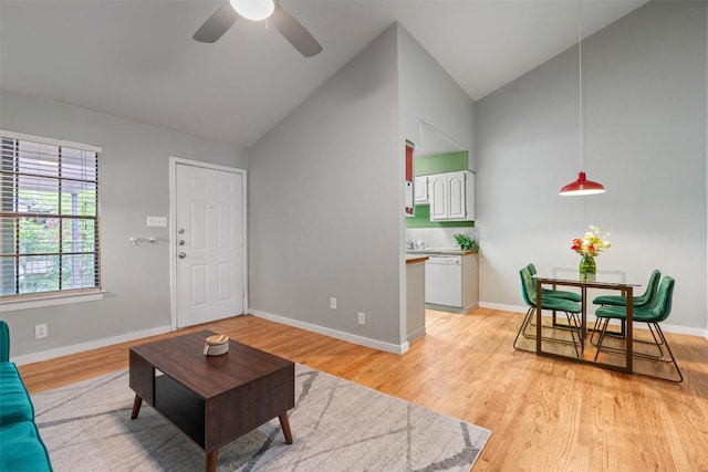 203 E 31st St Unit 304, Austin, TX 78705 - living area featuring a ceiling fan, light wood-type flooring, high vaulted ceiling, and baseboards