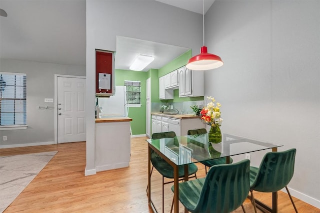 203 E 31st St Unit 304, Austin, TX 78705 - dining room featuring light wood-type flooring and baseboards