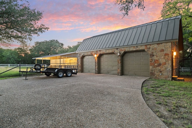 412 Haney Trce, Horseshoe Bay, TX 78657 - garage at dusk featuring driveway