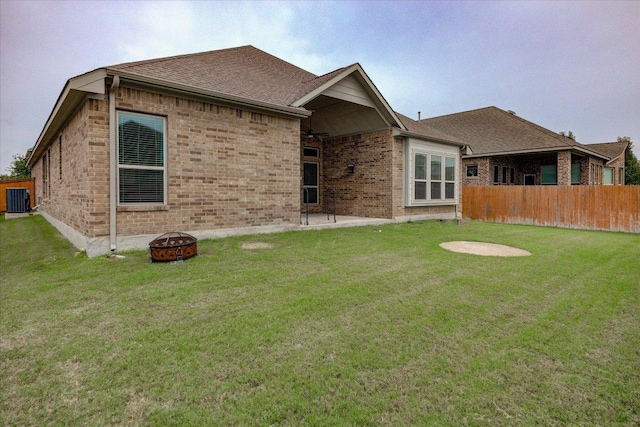 216 Allegrini St, Leander, TX 78641 - rear view of property with a fire pit, brick siding, cooling unit, and a shingled roof