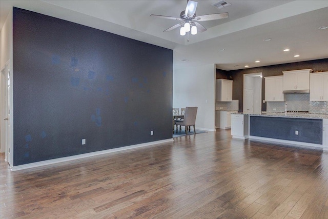 216 Allegrini St, Leander, TX 78641 - unfurnished living room with ceiling fan, wood finished floors, and recessed lighting