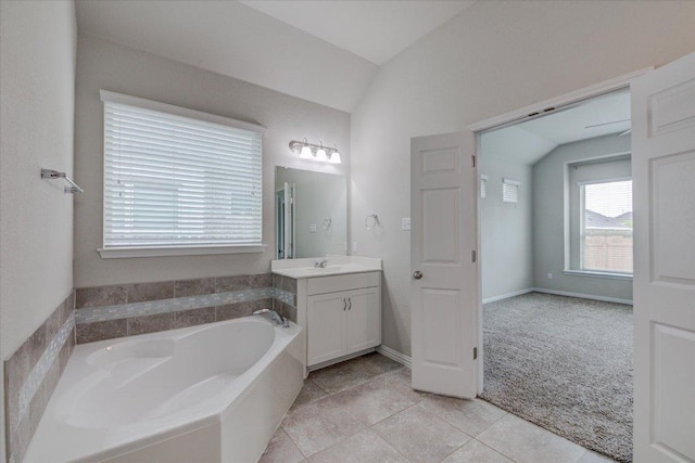 216 Allegrini St, Leander, TX 78641 - full bath with vanity, a bath, lofted ceiling, and tile patterned flooring