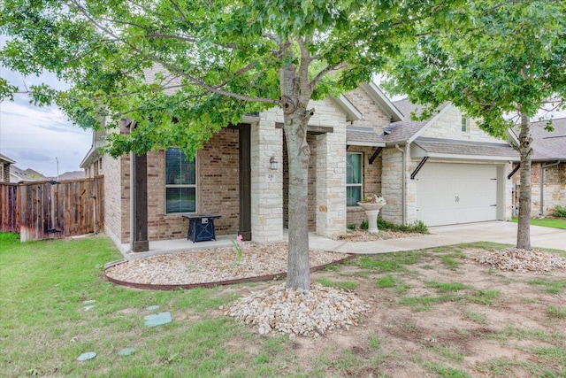 216 Allegrini St, Leander, TX 78641 - view of front of house featuring stone siding, driveway, a garage, and a shingled roof