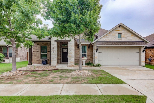 216 Allegrini St, Leander, TX 78641 - view of front of property featuring a garage, stone siding, driveway, and roof with shingles