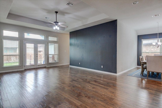 216 Allegrini St, Leander, TX 78641 - spare room with a raised ceiling, dark wood-style floors, ceiling fan, and a chandelier