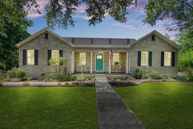 1922 W Lake Dr, Taylor, TX 76574 - view of front of property featuring a porch, stone siding, and a yard
