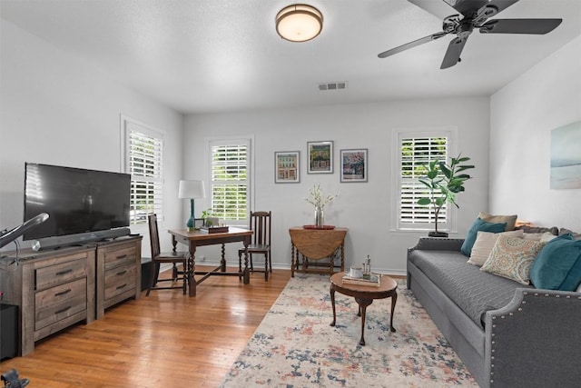 1922 W Lake Dr, Taylor, TX 76574 - living room featuring light wood-style flooring, healthy amount of natural light, ceiling fan, and an office area