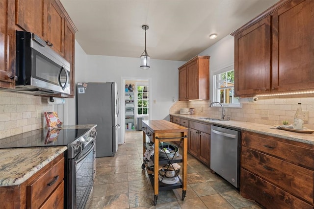 1922 W Lake Dr, Taylor, TX 76574 - kitchen with appliances with stainless steel finishes, backsplash, and plenty of natural light