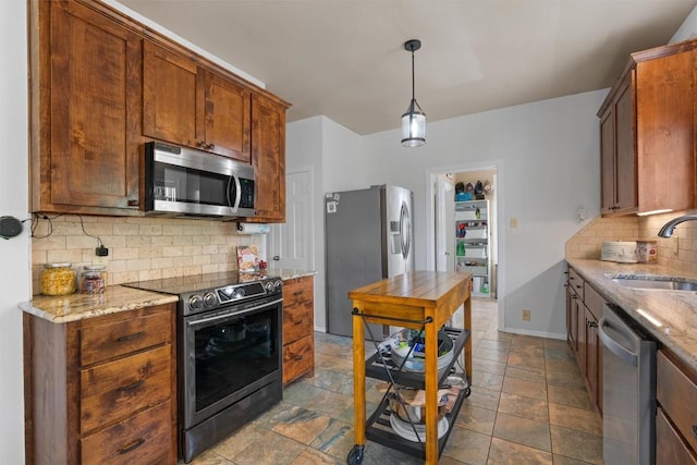 1922 W Lake Dr, Taylor, TX 76574 - kitchen featuring appliances with stainless steel finishes, decorative backsplash, light stone countertops, and dark stone finish flooring