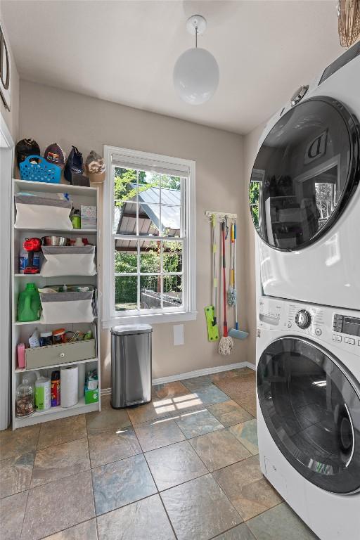 1922 W Lake Dr, Taylor, TX 76574 - laundry area featuring stacked washer / drying machine and stone finish floors
