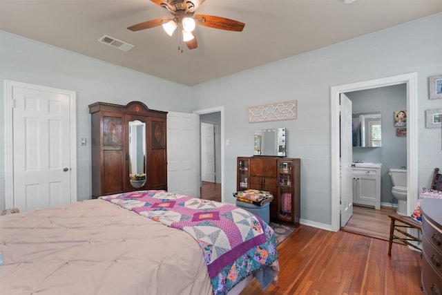 1922 W Lake Dr, Taylor, TX 76574 - bedroom featuring hardwood / wood-style flooring, ensuite bathroom, and ceiling fan