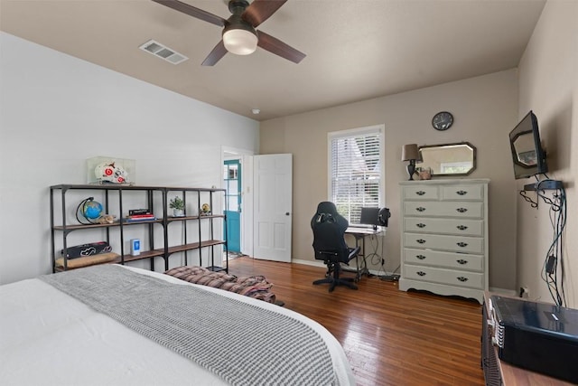 1922 W Lake Dr, Taylor, TX 76574 - bedroom with wood finished floors, a desk, and a ceiling fan