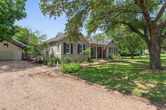 1922 W Lake Dr, Taylor, TX 76574 - view of front of house with a front lawn, dirt driveway, a carport, and stone siding