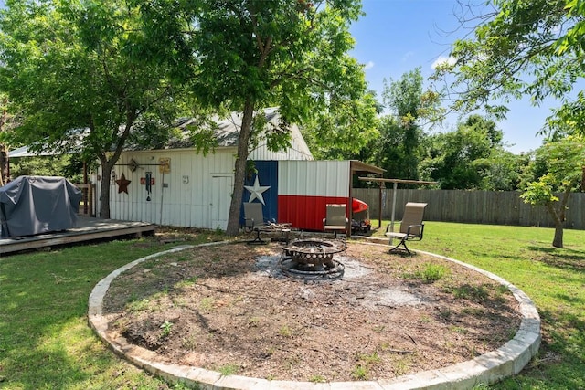 1922 W Lake Dr, Taylor, TX 76574 - view of yard featuring an outdoor fire pit, a wooden deck, and an outbuilding