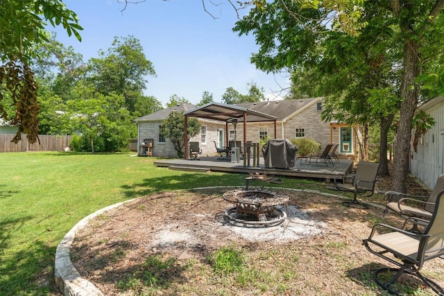 1922 W Lake Dr, Taylor, TX 76574 - back of property with an outdoor fire pit, a deck, and a pergola