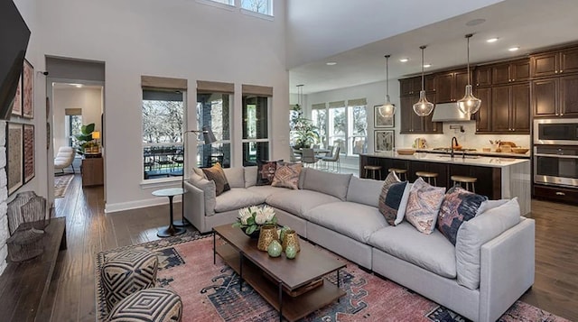 1316 Novara Trl, Leander, TX 78641 - living area featuring dark wood-style flooring, recessed lighting, and a high ceiling