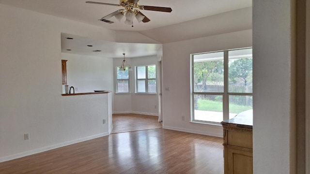 1111 Blazewood Dr, New Braunfels, TX 78130 - spare room with a ceiling fan, wood finished floors, a chandelier, baseboards, and lofted ceiling