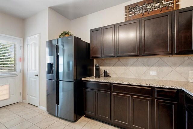 1407 Brashear Ct, Cedar Park, TX 78613 - kitchen featuring fridge with ice dispenser, tasteful backsplash, light tile patterned floors, and dark brown cabinets