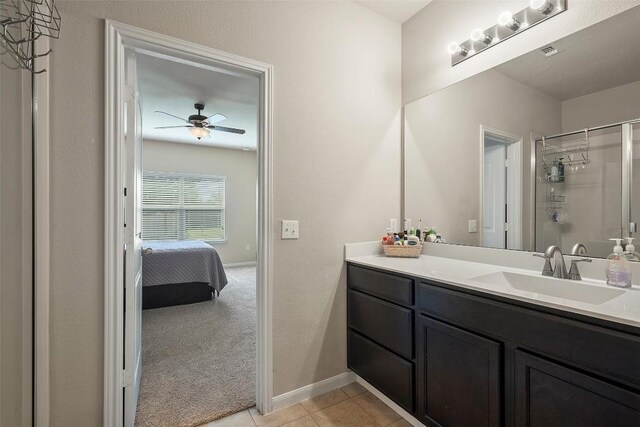 1407 Brashear Ct, Cedar Park, TX 78613 - bathroom featuring vanity, ceiling fan, a shower with door, tile patterned floors, and ensuite bathroom