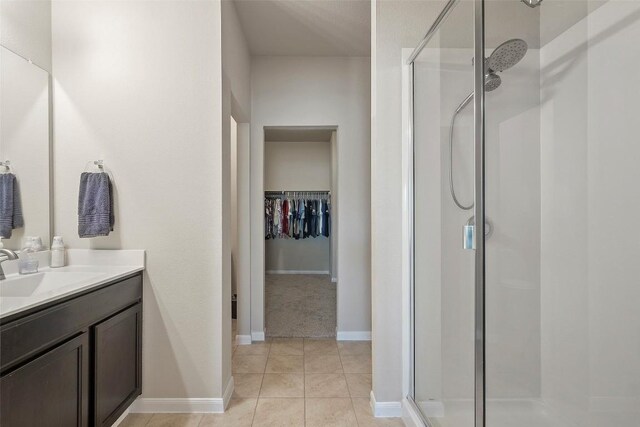 1407 Brashear Ct, Cedar Park, TX 78613 - full bathroom with a shower stall, vanity, a walk in closet, and tile patterned floors