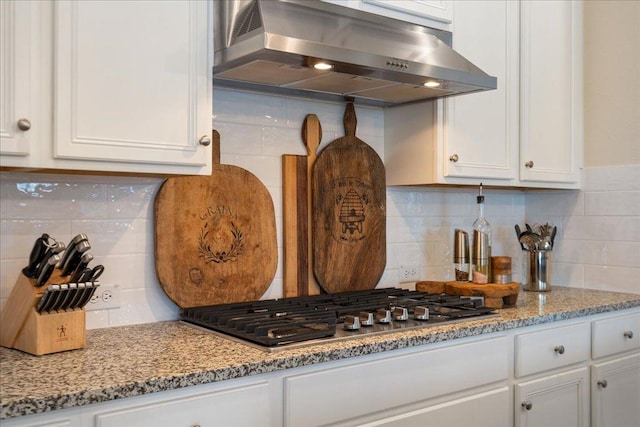 309 Singing Sumac Way, San Marcos, TX 78666 - kitchen with ventilation hood, backsplash, white cabinets, and stainless steel gas stovetop