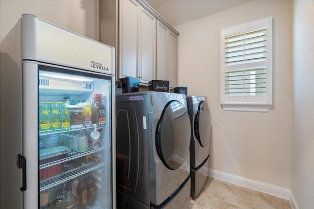 309 Singing Sumac Way, San Marcos, TX 78666 - laundry room with cabinet space, separate washer and dryer, and light tile patterned flooring