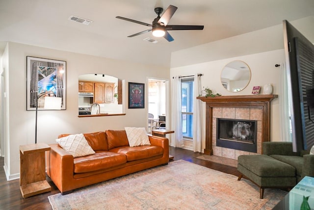 2152 Stonecrest Path, New Braunfels, TX 78130 - living room featuring dark wood-style floors, ceiling fan, a tiled fireplace, lofted ceiling, and baseboards