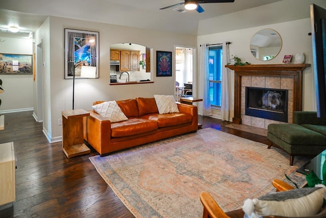 2152 Stonecrest Path, New Braunfels, TX 78130 - living room with dark wood-type flooring, ceiling fan, baseboards, and a tile fireplace
