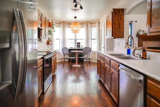 2152 Stonecrest Path, New Braunfels, TX 78130 - kitchen with appliances with stainless steel finishes, a sink, under cabinet range hood, light countertops, and dark wood-style flooring