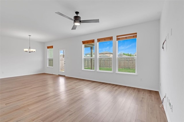 13308 Nancy Reagan St, Manor, TX 78653 - unfurnished room featuring a chandelier, light wood-style flooring, and a ceiling fan