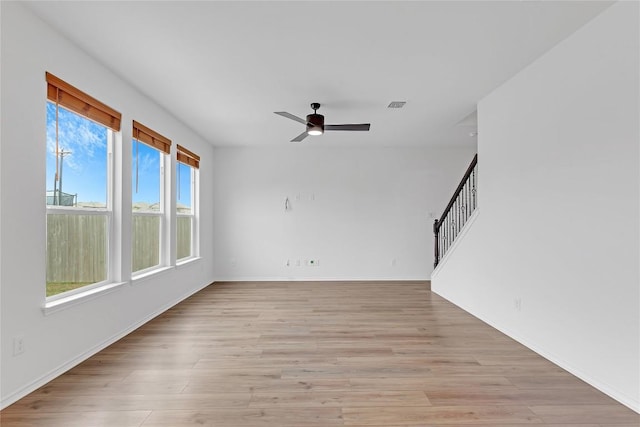 13308 Nancy Reagan St, Manor, TX 78653 - unfurnished living room featuring ceiling fan, stairs, and light wood-type flooring