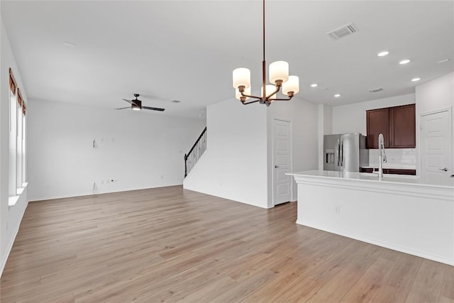 13308 Nancy Reagan St, Manor, TX 78653 - kitchen featuring stainless steel fridge, ceiling fan, light wood-style floors, open floor plan, and recessed lighting