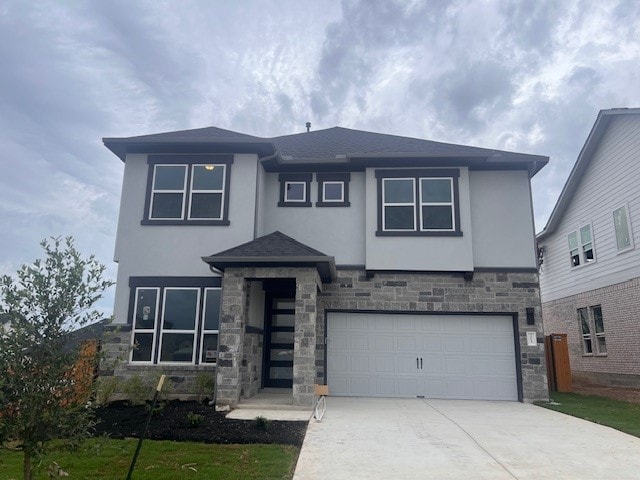 20013 Aqua Reef Dr, Austin, TX 78747 - view of front of home with stucco siding, stone siding, a garage, and concrete driveway