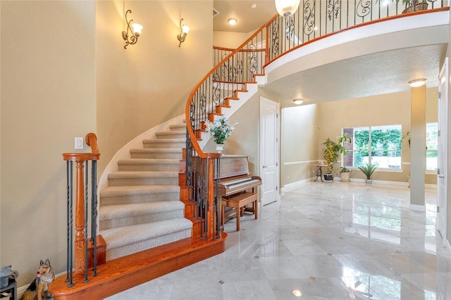222 Vailco Ln, Austin, TX 78738 - stairway with marble tiled floors and a towering ceiling