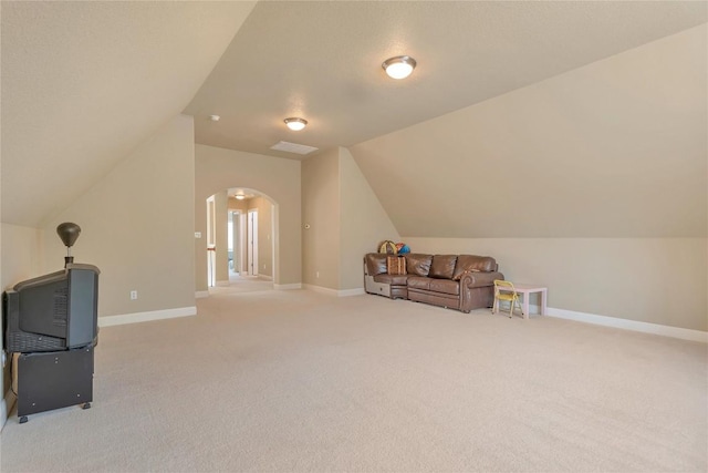 222 Vailco Ln, Austin, TX 78738 - sitting room featuring lofted ceiling, arched walkways, and carpet flooring