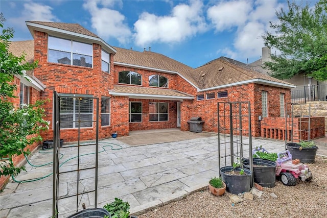 222 Vailco Ln, Austin, TX 78738 - rear view of property featuring a patio and brick siding