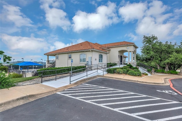 222 Vailco Ln, Austin, TX 78738 - view of front of property with a tile roof, uncovered parking, and stucco siding