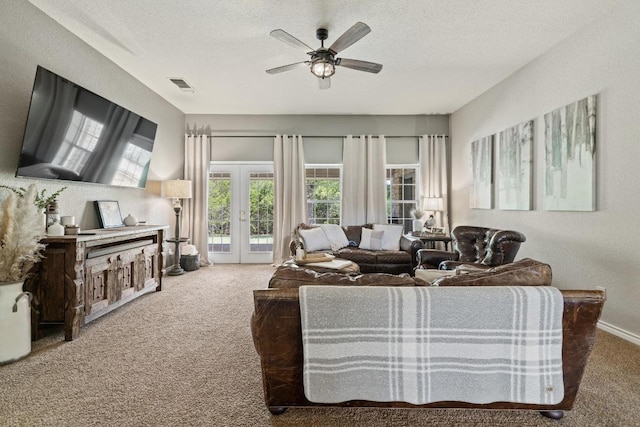 1201 County Road 229, Florence, TX 76527 - carpeted living room featuring french doors, a textured ceiling, and ceiling fan