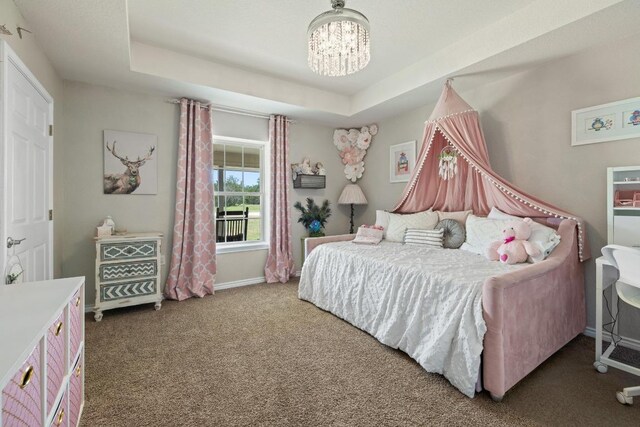 1201 County Road 229, Florence, TX 76527 - bedroom with carpet floors, a chandelier, and a raised ceiling
