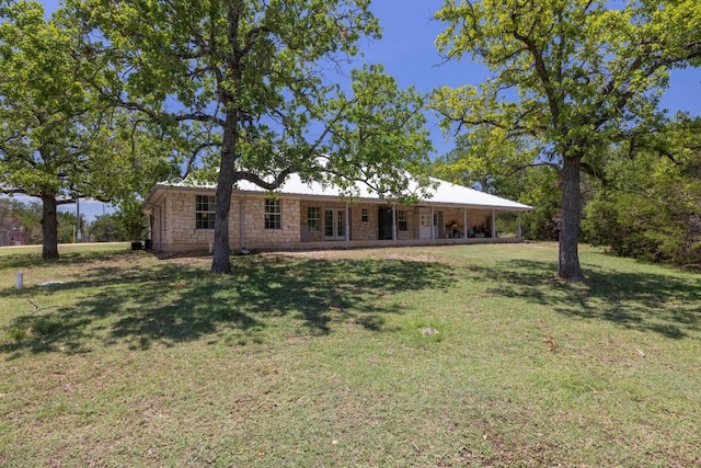 1201 County Road 229, Florence, TX 76527 - view of front of property with a front yard, stone siding, and french doors