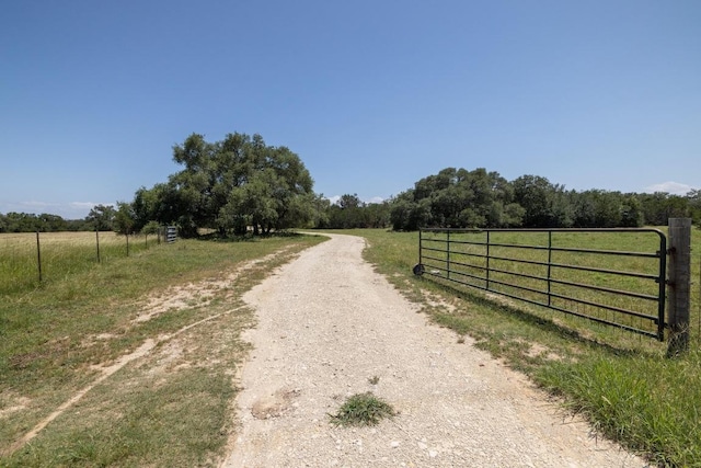 1201 County Road 229, Florence, TX 76527 - view of road featuring a rural view and a gate