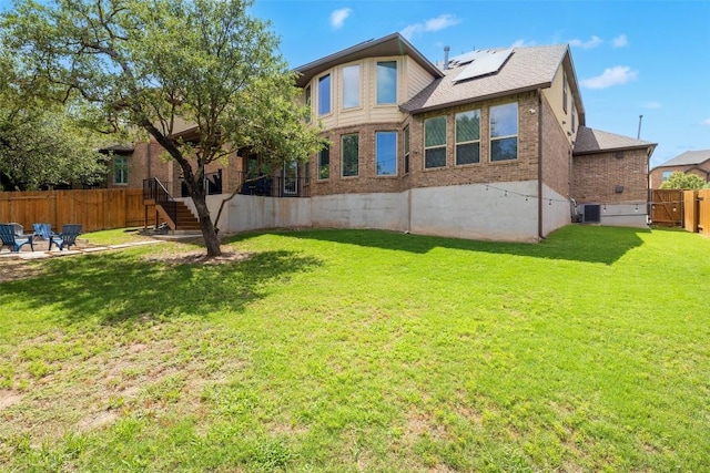 4225 Borho Ranch St, Leander, TX 78641 - rear view of property with brick siding, roof mounted solar panels, roof with shingles, and a patio