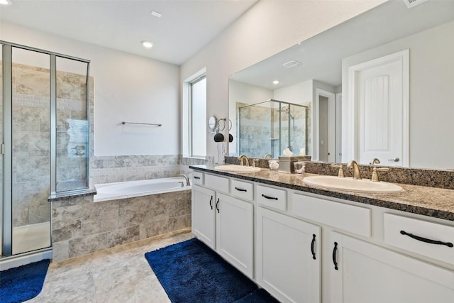 4225 Borho Ranch St, Leander, TX 78641 - full bathroom featuring a shower stall, double vanity, a garden tub, tile patterned floors, and recessed lighting