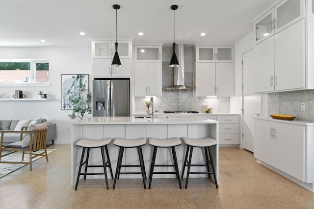 2500 Southland Dr Unit B, Austin, TX 78704 - kitchen with stainless steel fridge, wall chimney exhaust hood, tasteful backsplash, a kitchen bar, and recessed lighting
