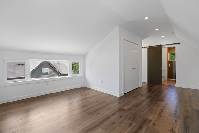 2500 Southland Dr Unit B, Austin, TX 78704 - additional living space with lofted ceiling, a barn door, wood finished floors, and recessed lighting